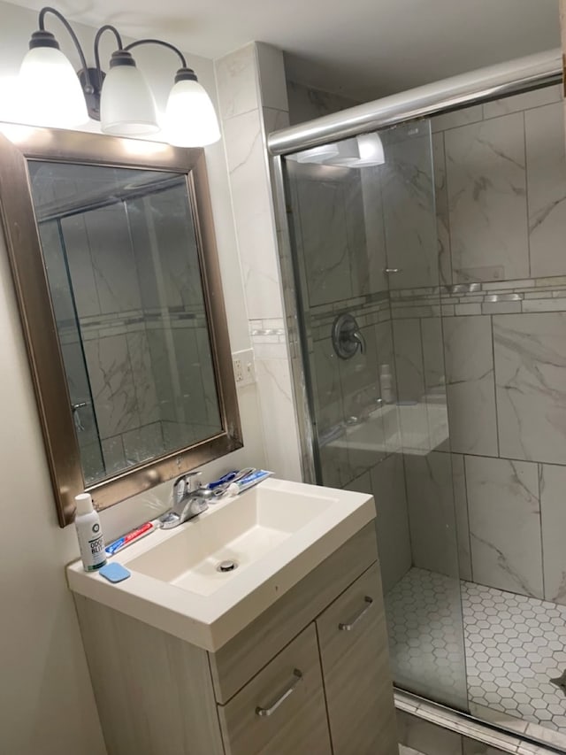 bathroom with vanity and a shower with shower door