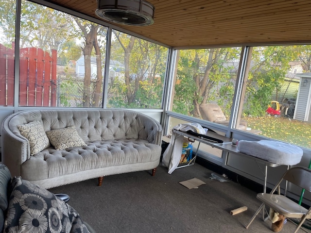 sunroom / solarium with a healthy amount of sunlight and wood ceiling