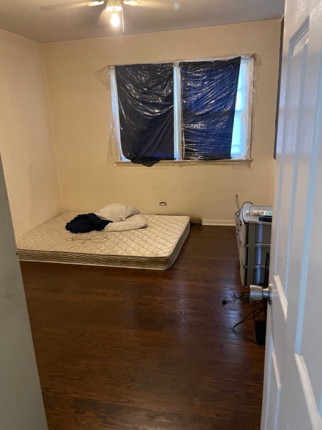 bedroom featuring dark hardwood / wood-style floors and ceiling fan