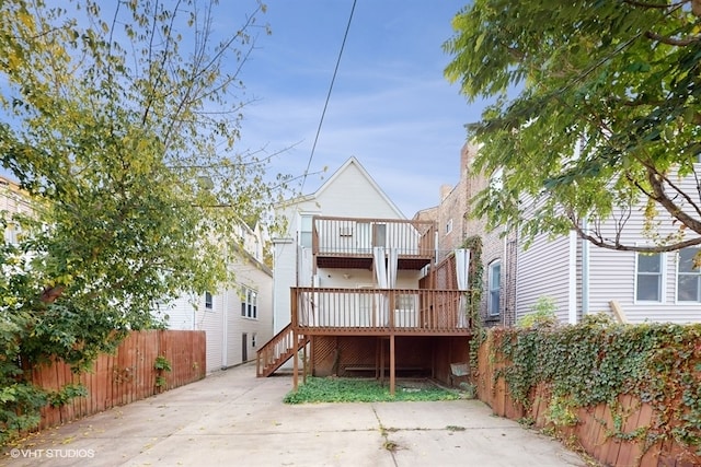 back of house with a wooden deck