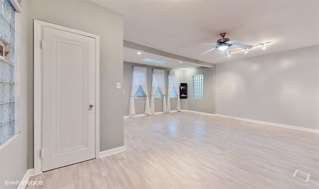 empty room featuring ceiling fan and light hardwood / wood-style floors