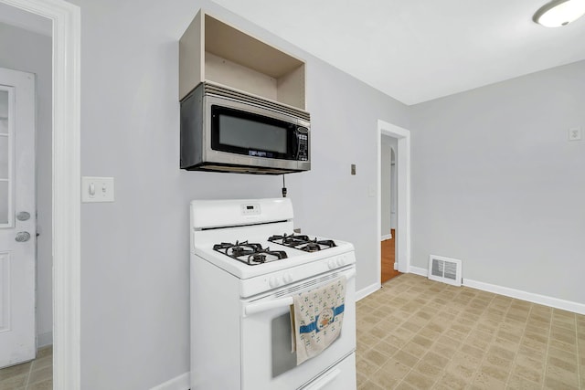 kitchen with white gas range oven