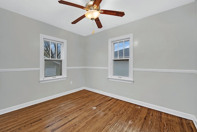 spare room with hardwood / wood-style flooring, ceiling fan, and a healthy amount of sunlight