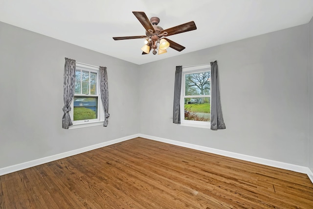 unfurnished room with hardwood / wood-style flooring and ceiling fan