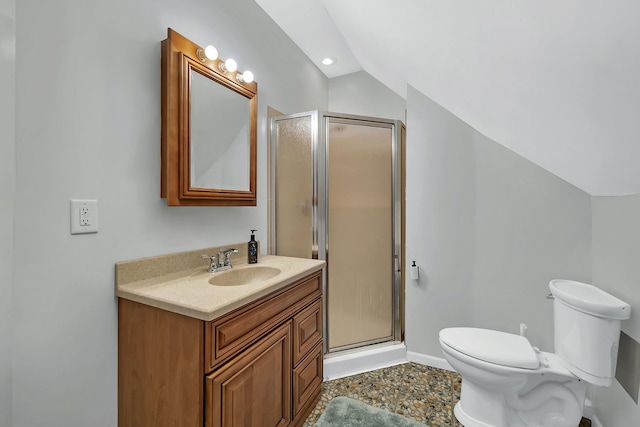 bathroom with a shower with door, vanity, vaulted ceiling, and toilet