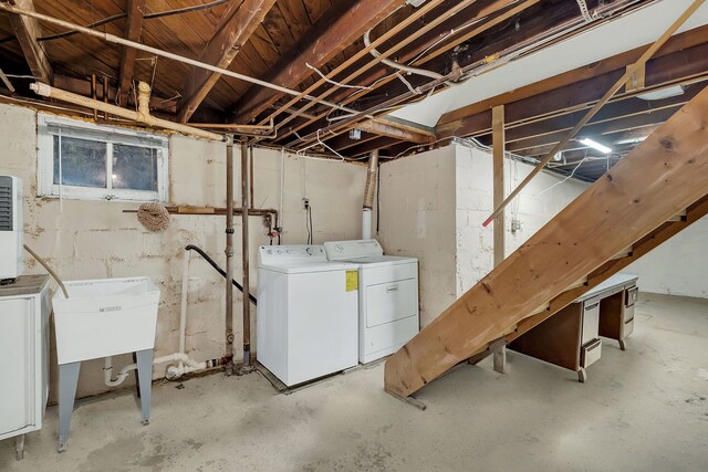 basement with sink and washer and dryer