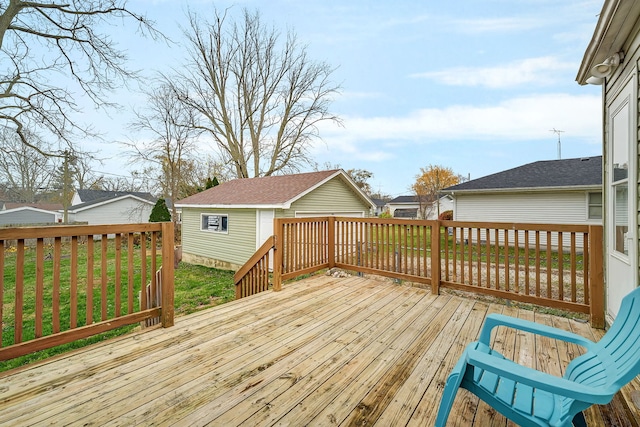 wooden deck with an outbuilding and a yard