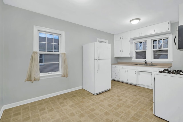 kitchen featuring white cabinets, white appliances, and sink