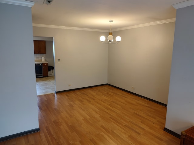 empty room featuring ornamental molding, light hardwood / wood-style floors, and a notable chandelier