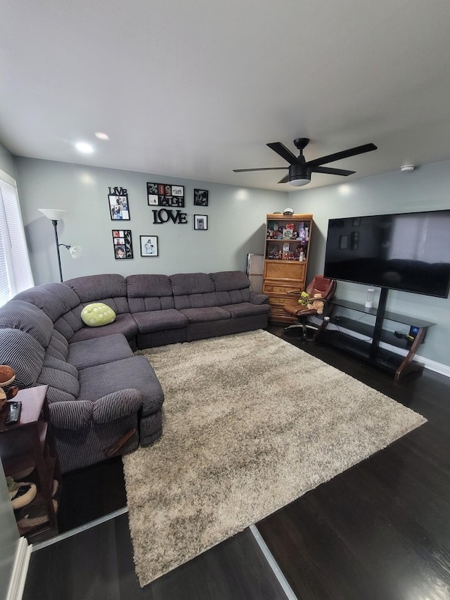 living room featuring dark hardwood / wood-style flooring and ceiling fan