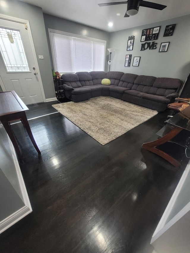 living room featuring dark hardwood / wood-style floors and ceiling fan