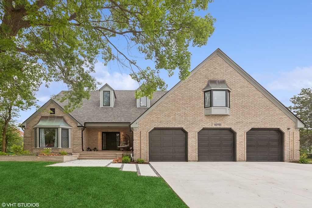 view of front facade with a garage and a front lawn