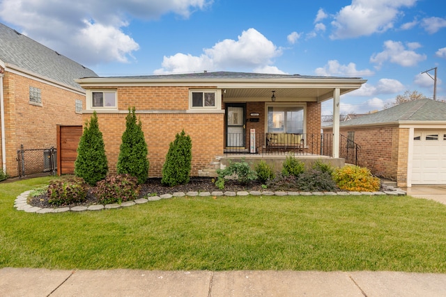 view of front of home featuring a porch, a garage, and a front lawn