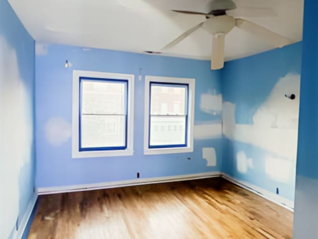 unfurnished room featuring hardwood / wood-style flooring and ceiling fan