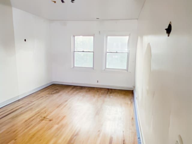 spare room featuring hardwood / wood-style flooring