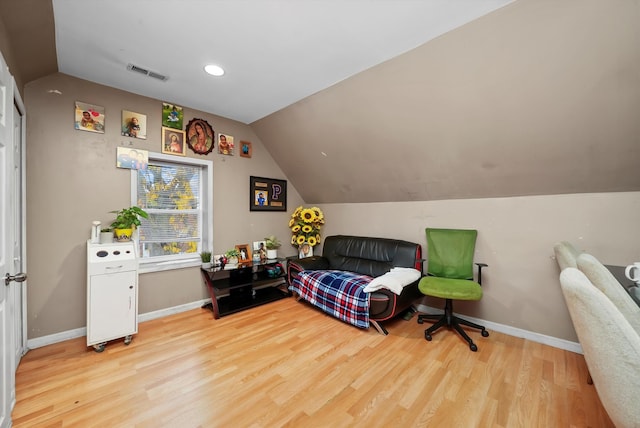 bedroom featuring light hardwood / wood-style floors and vaulted ceiling