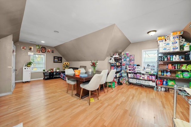 dining space with hardwood / wood-style flooring and lofted ceiling