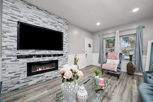 living room with a fireplace and light hardwood / wood-style floors