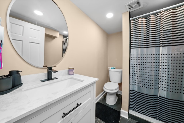 bathroom featuring curtained shower, tile patterned flooring, vanity, and toilet