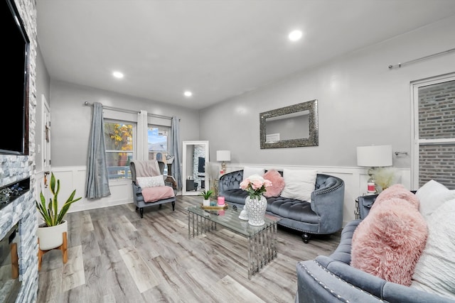 living room with a fireplace and light hardwood / wood-style flooring