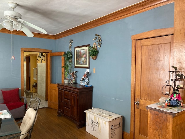 interior space with dark hardwood / wood-style flooring, ceiling fan, and crown molding