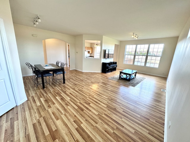 living room featuring light hardwood / wood-style flooring and a notable chandelier