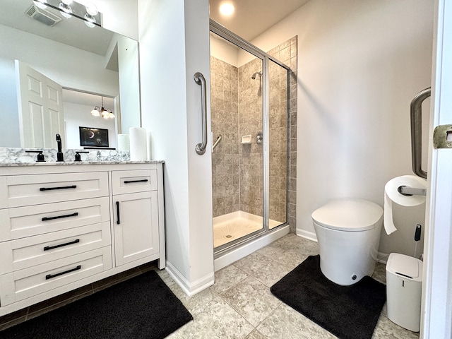 bathroom featuring an inviting chandelier, tile patterned flooring, toilet, vanity, and a shower with shower door