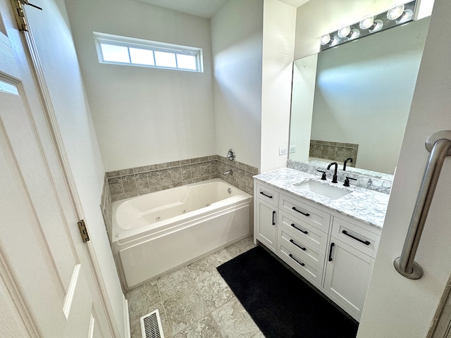 bathroom featuring a washtub and vanity