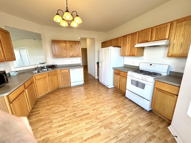 kitchen featuring sink, a notable chandelier, pendant lighting, light hardwood / wood-style floors, and white appliances