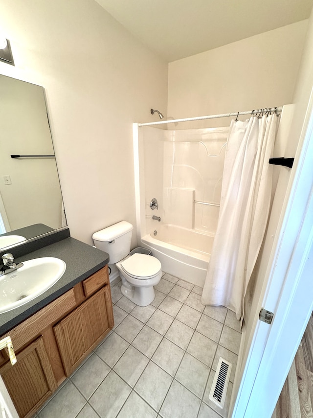 full bathroom featuring tile patterned flooring, vanity, toilet, and shower / tub combo