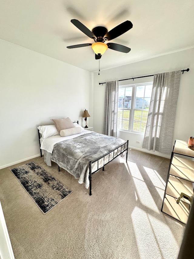 bedroom with ceiling fan and light carpet