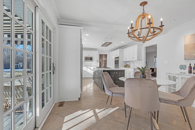 dining space featuring light tile patterned flooring, a notable chandelier, and crown molding