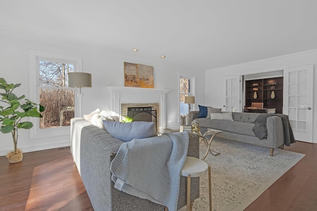 living room featuring ornamental molding and dark hardwood / wood-style flooring