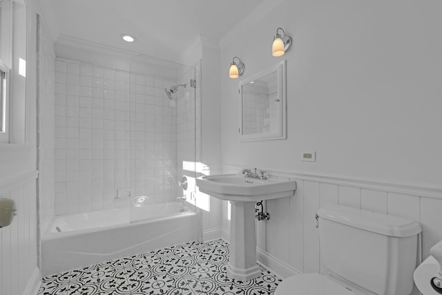 full bathroom with sink, tiled shower / bath combo, ornamental molding, tile patterned flooring, and toilet