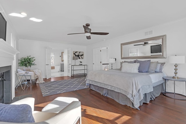 bedroom with ornamental molding, dark hardwood / wood-style flooring, and ceiling fan