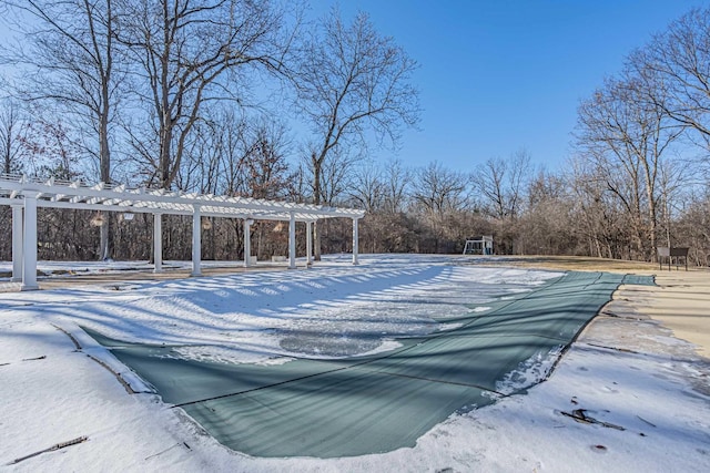 snow covered pool featuring a pergola