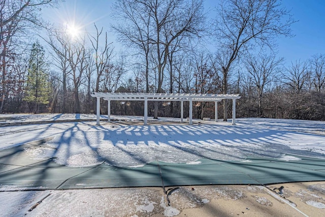 snow covered pool featuring a pergola