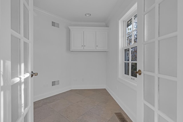 washroom with ornamental molding and light tile patterned floors