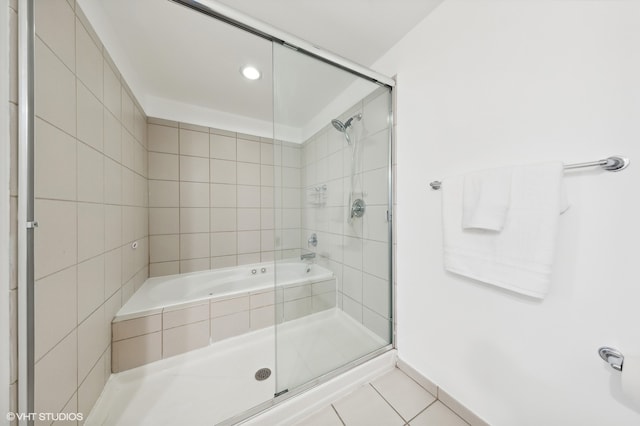 bathroom with tile patterned floors and a shower with shower door