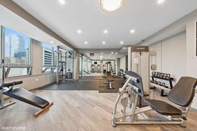 exercise room with wood-type flooring