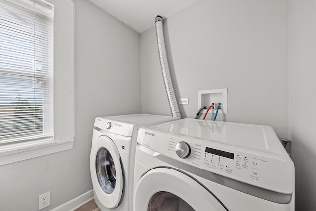 clothes washing area featuring independent washer and dryer