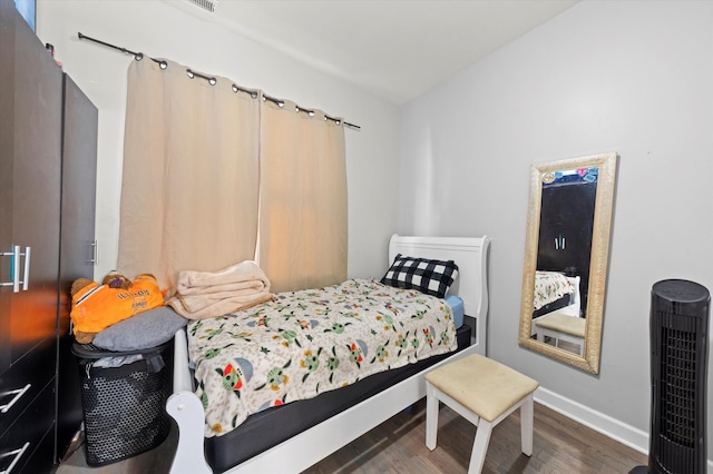 bedroom featuring dark hardwood / wood-style flooring