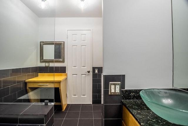 bathroom with tile patterned flooring, vanity, and tile walls