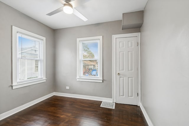 empty room featuring ceiling fan and dark hardwood / wood-style flooring