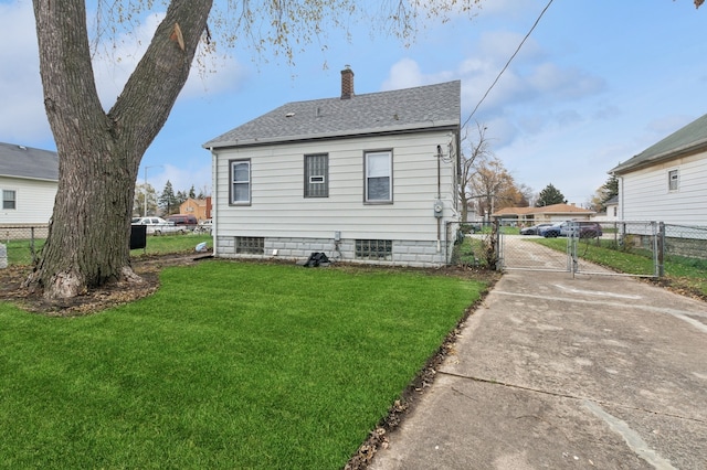 back of property featuring a yard