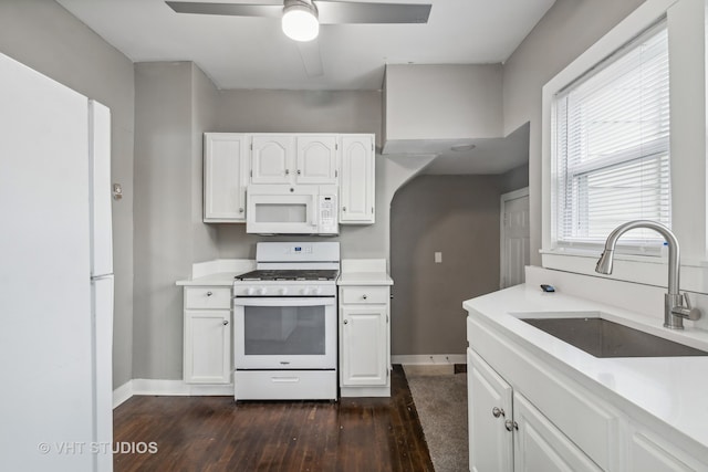 kitchen with white cabinets, white appliances, dark hardwood / wood-style floors, and sink