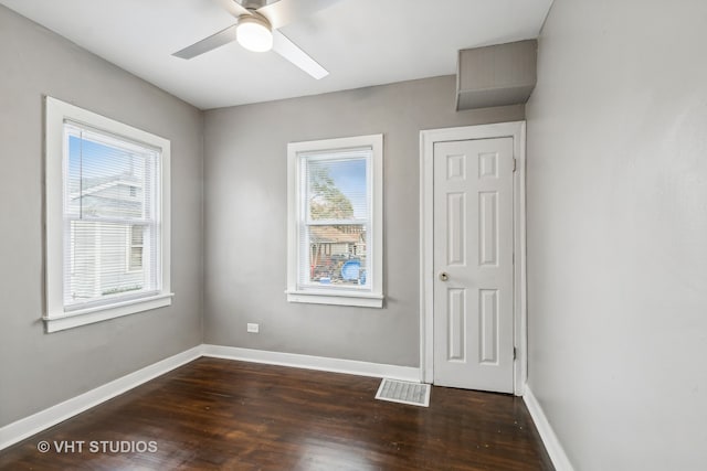 empty room featuring ceiling fan and dark wood-type flooring