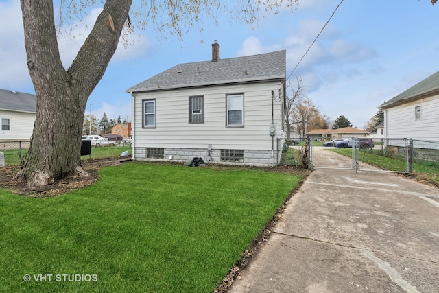 rear view of house featuring a lawn