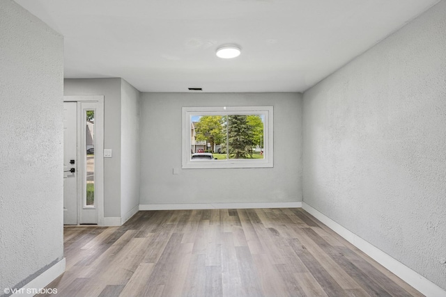 1130 Sandpiper Ct, Bartlett, IL 60103 - spare room featuring a textured wall, wood finished floors, and baseboards