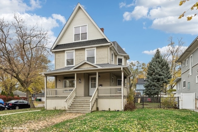 view of front of home with a porch and a front lawn